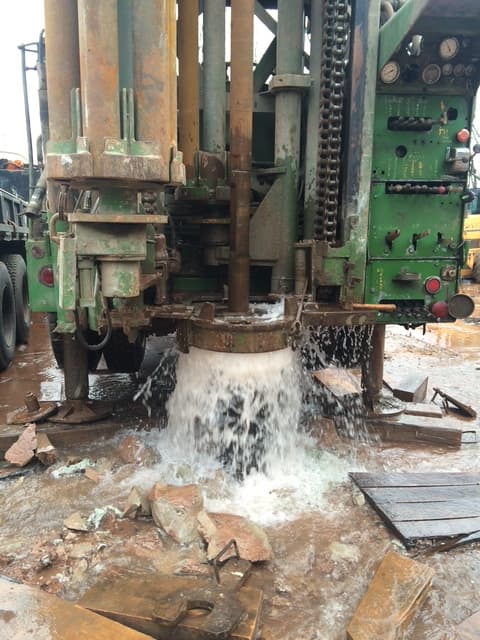 Water flowing during a large capacity water well installation
