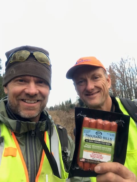 Founders Dan and Peter smiling in field gear after field work